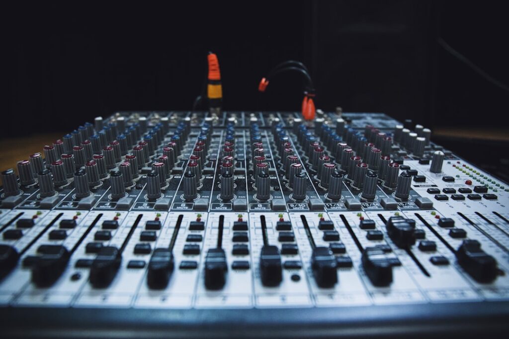 Professional audio mixing console with multiple channels and controls for podcast production