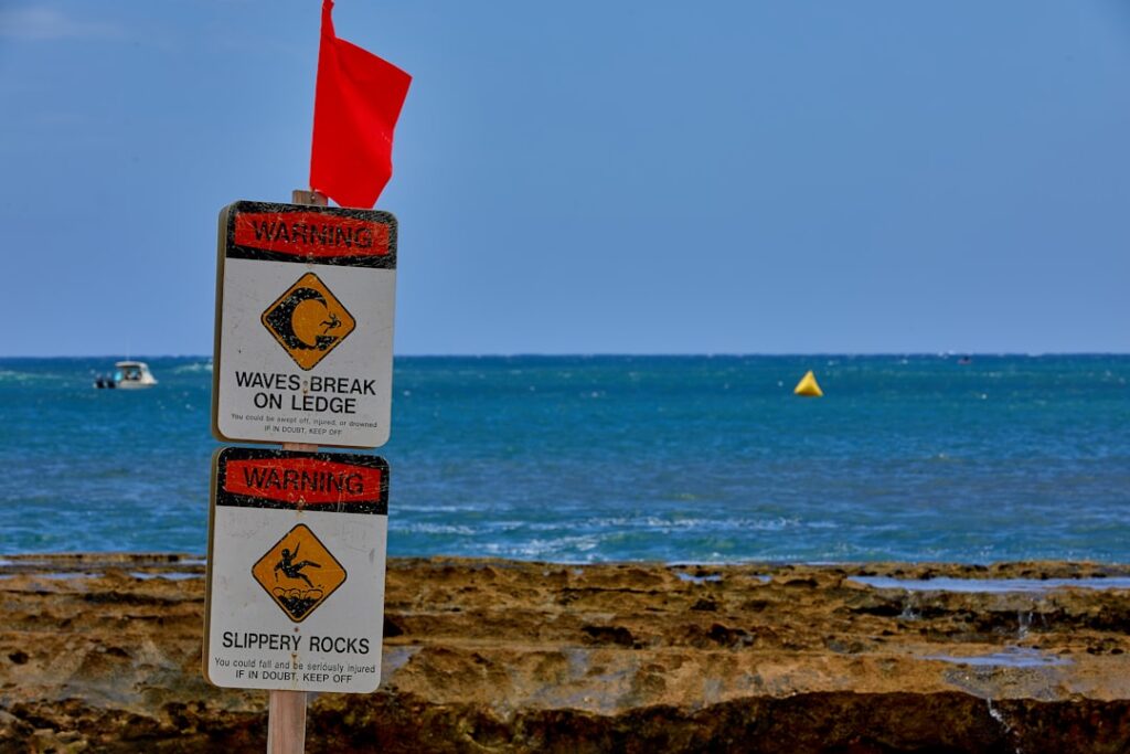 Red warning flags and caution signs indicating dangerous conditions - metaphor for business red flags when vetting agencies